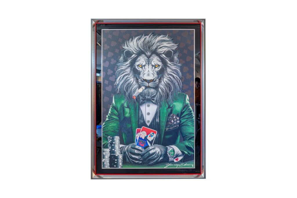 Yaniv Edery - Lion Poker Green Suit This artwork exudes power, luxury and mystery. A proud lion, the king of animals, sits confidently at the poker table. Dressed in a stylish green suit, he exudes power and elegance. The eyes are sharp, the posture unwavering. The card in his hand symbolizes strategy and dominance. The green suit gives the work an energetic look. Green represents balance, growth and success. The black bow tie and white shirt bring sophistication and contrast. At the same time, the background with heart patterns emphasizes the intensity of the poker game. Every detail is carefully crafted, from the smoke of the cigar to the shine on the chips. This work is not only decorative, but also meaningful. It shows how instinct and intelligence come together in play and in life. The lion is a symbol of courage and leadership. In this artwork, he is presented as a player and winner, but also as an icon of style. Lion Poker Green Suit is thus a perfect combination of art, strength and luxury. It is a statement piece that instantly attracts attention and adds character to any space.