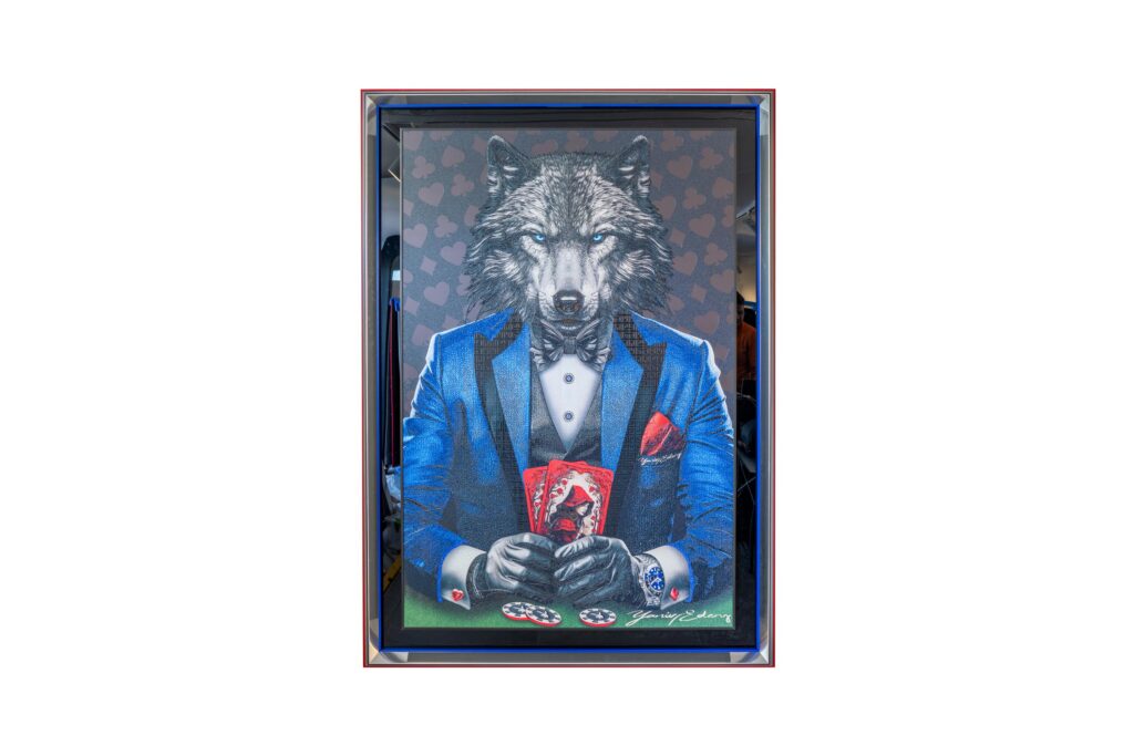Yaniv Edery - Wolf Poker Blue Suit is a powerful work of art that makes an immediate impression. Clad in an elegant blue suit, the wolf exudes dominance and strategy. His sharp gaze and controlled posture betray experience, insight and unwavering determination. This artwork is not only about poker, but also about power, control and style. The wolf sits tight in his blue suit, finished with subtle red accents. The contrast between the cool blue and the fiery details emphasizes tension and balance. He holds his cards close, ready to strike. Each brush stroke reinforces the intensity and power of this work. The symbolism is clear. The wolf represents instinct, intelligence and leadership. Combined with poker, a game of risk and strategy, it creates a fascinating metaphor. This work is an ode to guts and calculation, to elegance and wildness. The blue suit symbolizes tranquility, loyalty and confidence. Yet the wolf's gaze betrays another side: sharp, observant and always alert. It is this double layer that gives the artwork its unique power. Wolf Poker Blue Suit is more than decoration. It is a visual experience that continues to intrigue. A masterful play between art, emotion and symbolism. It is a statement that elevates any space and grabs immediate attention.